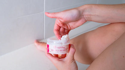 Texture onctueuse de la chantilly de karité naturelle, prélevée avec le doigt pour le soin du corps